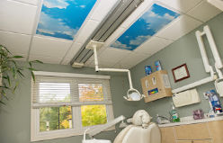inside dental treatment room shows blue sky and cload panels on ceiling at Munroe Falls Family Dentistry near Akron Ohio on Route 91
